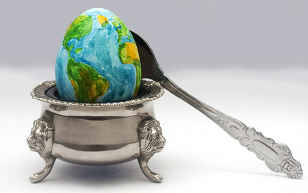 the earth in the image of the egg lies on a plate before dinner timeの写真素材
