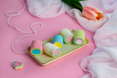 colorful marshmallows in ceramic rectangular plate on pink background