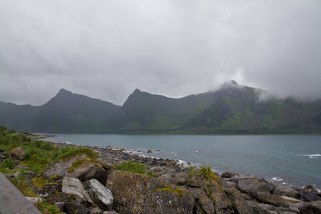 A view from wharf on some norway's peak in a bad weatherの写真素材