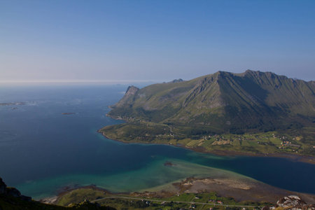 Beautiful landscape from bird view with some mountains, bay, ocean and riverside villageの写真素材