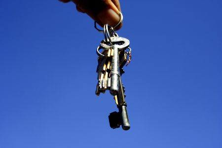 A hand holding a keysの写真素材