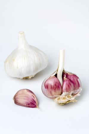garlic bulb and cloves on a white backgroundの写真素材