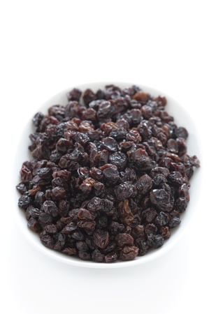 dried currants in a dish isolatedの写真素材