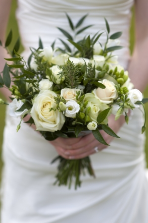 bride holding a bouquet of flowers with rosesの写真素材