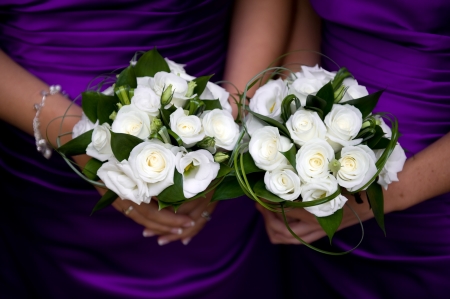 bridesmaids holding bouquet of flowers at a weddingの写真素材