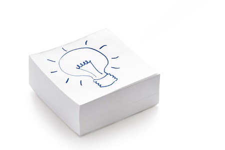 lightbulb drawing on a stack of post it notes illustrating the concept of having an ideaの写真素材