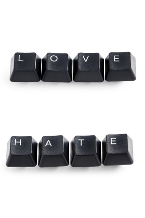 computer keys isolated on white spelling the word love and hateの写真素材