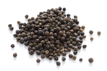 heap of black peppercorns isolated on a white backgroundの写真素材