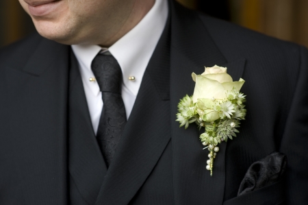man wearing black suit and floral buttonholeの写真素材
