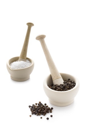 salt crystals and black peppercorns in pestle and mortarの写真素材