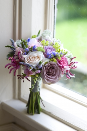 wedding bouquet of flowers near a windowの写真素材