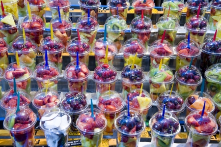 chopped fresh fruit for sale in individual portionsの写真素材