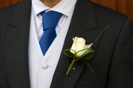 groom wearing a white rose buttonhole at weddingの写真素材