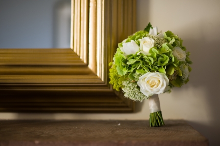 wedding bouquet of white roses with gold frame mirror and shelfの写真素材