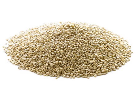 quinoa grains in a heap isolated on a white backgroundの写真素材