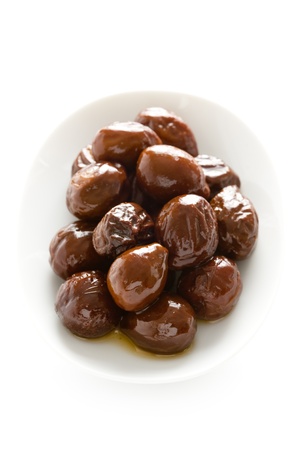 canned prunes on a white dish isolatedの写真素材