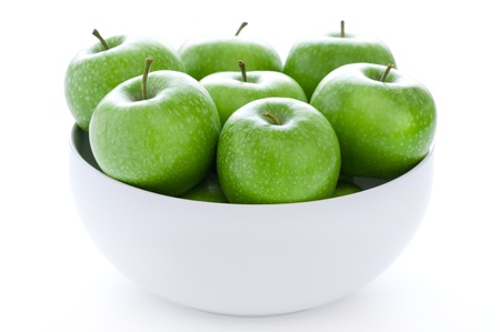 fresh green granny smith apples in a white bowlの写真素材