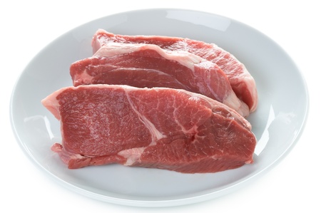 raw lamb leg steaks isolated on a white backgroundの写真素材