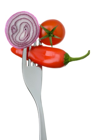  fresh red onion cherry tomato and chilli on a fork against whiteの写真素材