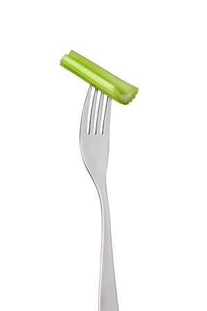 section of celery stalk on a fork isolated against white backgroundの写真素材