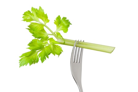 fresh celery stalk on a fork isolated against a white backgroundの写真素材