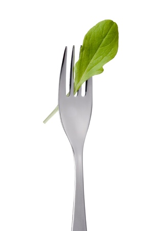 single lettuce leaf on a fork isolated against white backgroundの写真素材