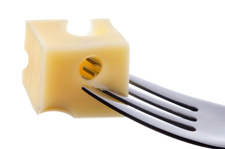 emmental cheese cube on a fork against white backgroundの写真素材