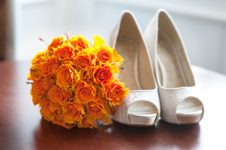 wedding shoes and bouquet of orange roses nobodyの写真素材