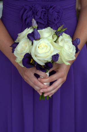 bridesmaid in purple with white rose bouquetの写真素材