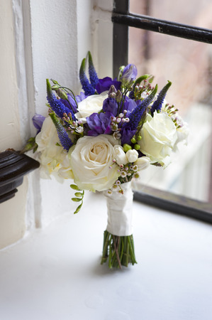 wedding bouquet of white and purple rosesの写真素材