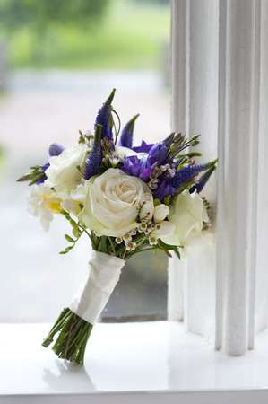 wedding bouquet of white and purple rosesの写真素材