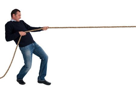 man pulling a rope tug of war isolated white backgroundの写真素材