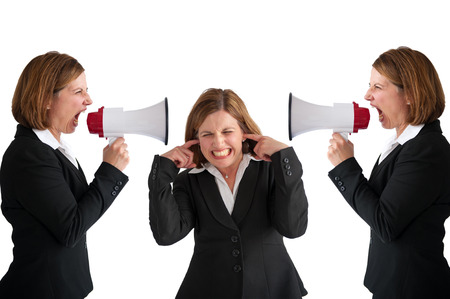 businesswoman being shouted at by businesswomen with megaphoneの写真素材