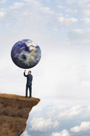global business concept businessman spinning earth on one fingerの写真素材