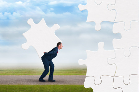 business puzzle concept businessman faces adversity to solve jigsawの写真素材