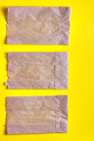Reusable paper packages on the bright yellow background. Concept of the zero waste lifestyle, ecology safety, recycled waste, environment protection, Earth dayの写真素材
