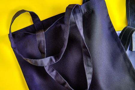 Tote bag made with natural materials on the bright yellow background. Concept of the zero waste...