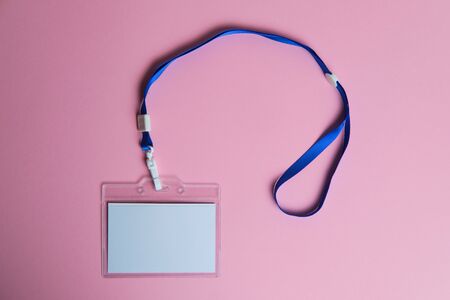 security badge lying on colorful pink background with blank copy space for text addition, event invitation concept, text insertの写真素材