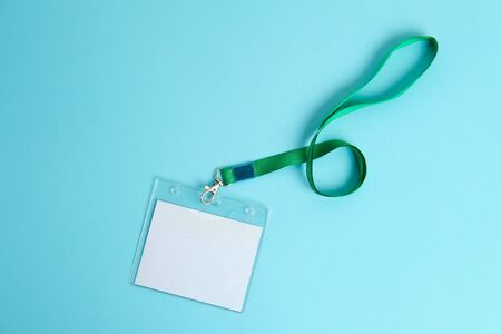 security badge lying on colorful blue background with blank copy space for text addition, event invitation concept, text insertの写真素材