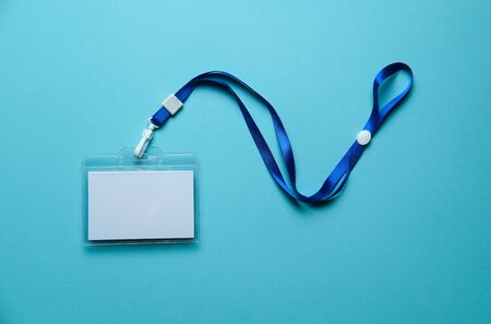 security badge lying on colorful blue background with blank copy space for text addition, event invitation concept, text insertの写真素材