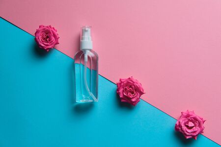 Roses spray antiseptic fragrance with blank space for text insertion, blue background for natural gmo free cosmeticsの写真素材
