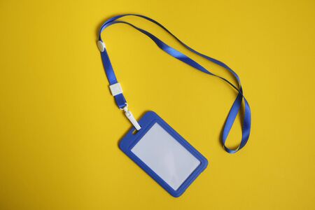 security badge lying on yellow background with blank copy space for text addition, event invitation...