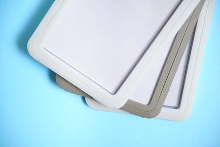 Bunch of security badges lying on blue background with blank copy space for text addition, event...