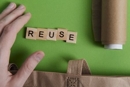 reduce, reuse and recycle word in vintage wooden letterpress type blocks, flatlay on green fontの写真素材