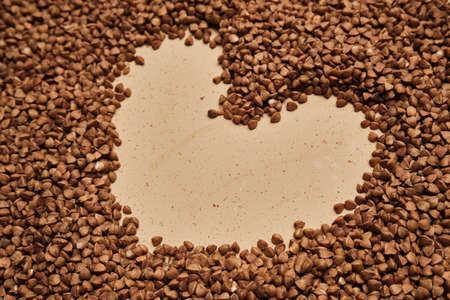 buckwheat on a backdrop. rustic buckwheat background. buckwheat heart signの写真素材