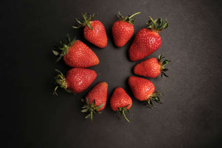 Red strawberries on dark chalkboard with copy spaceの写真素材