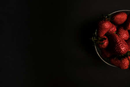 Red strawberries on dark chalkboard with copy spaceの写真素材