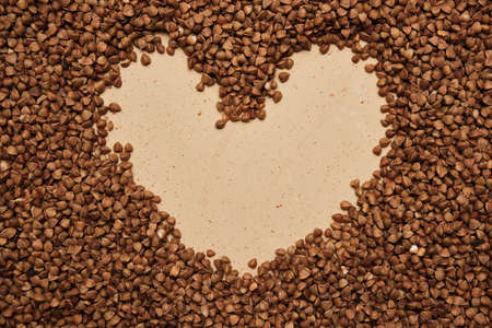 buckwheat on a backdrop. rustic buckwheat background. buckwheat heart signの写真素材