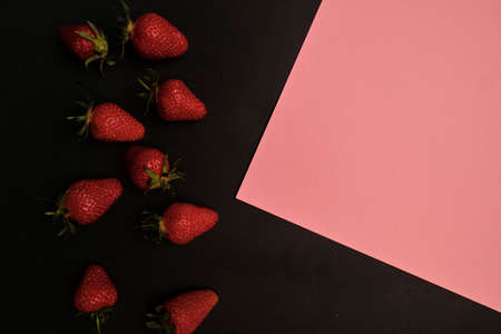 Red strawberries on dark chalkboard with space for your textの写真素材