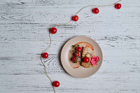 pork steak, grilled and served with cherry tomatoes on white wood table.の写真素材